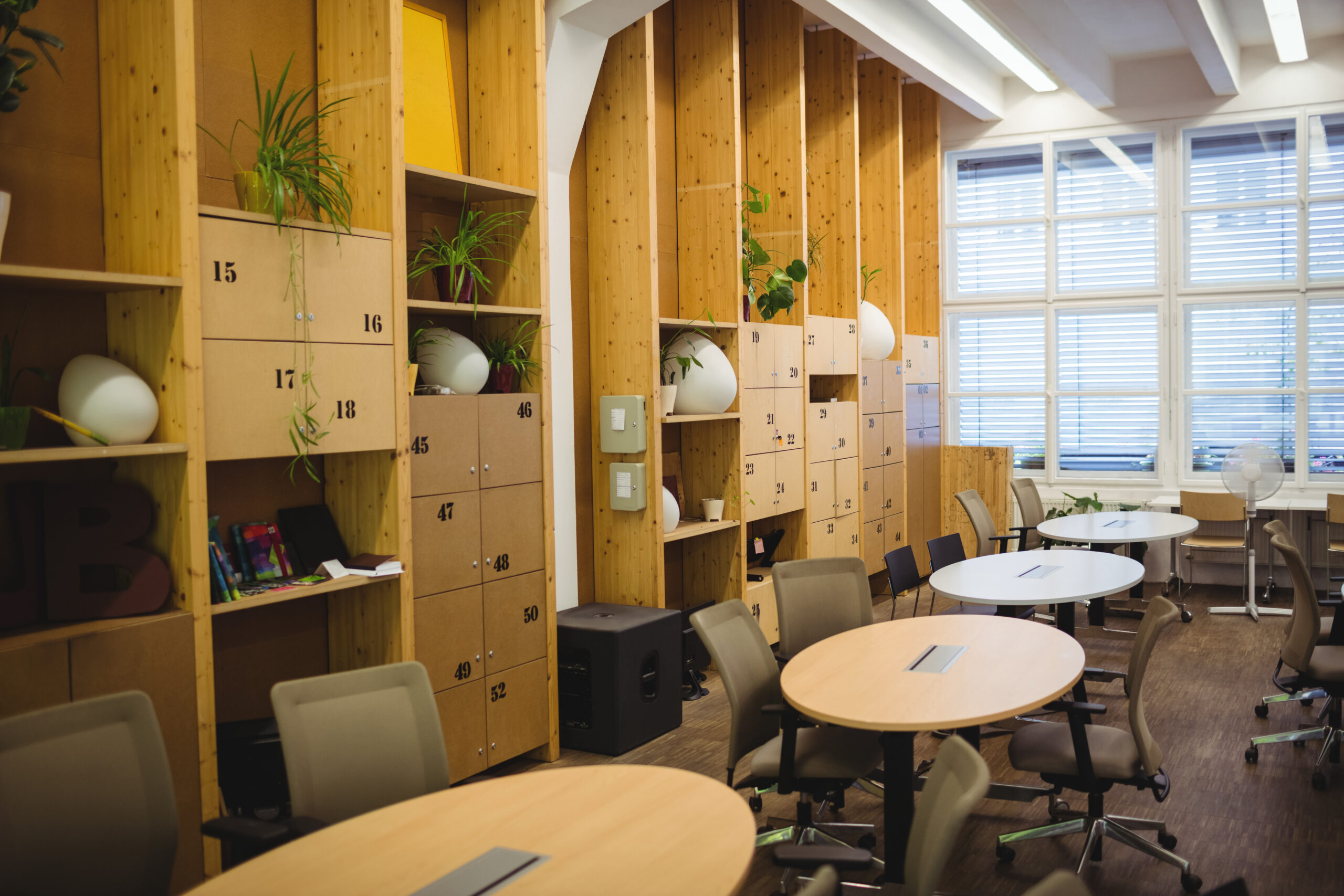 View of empty office workplace with table, chair and locker